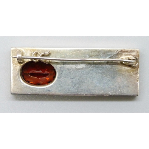 7097 - A Modernist .935 silver leaf design brooch set with a red stone (testing within the spinel region so... 
