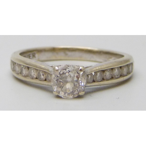 7112 - An 18ct white gold natural diamond ring, the central stone 0.6ct, with diamond set shoulders, 3.8g, ... 