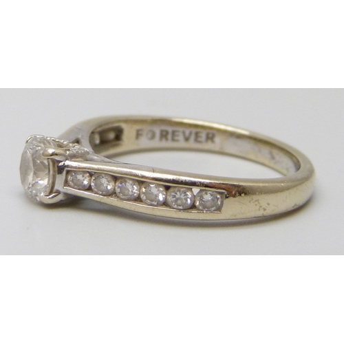 7112 - An 18ct white gold natural diamond ring, the central stone 0.6ct, with diamond set shoulders, 3.8g, ... 