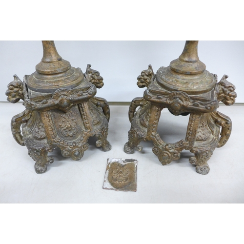 2033 - A pair of metal ornate candlesticks, 20cm
