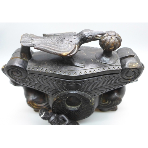 2039 - A set of Eastern opium scales housed in carved wooden box with hinged lid and bird detail, 17cm wide