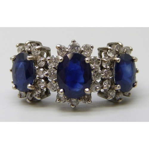 7261 - An 18ct white gold, sapphire and diamond triple cluster ring, 5.6g, N