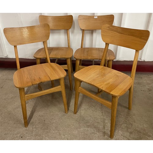 65 - A set of four light oak dining chairs