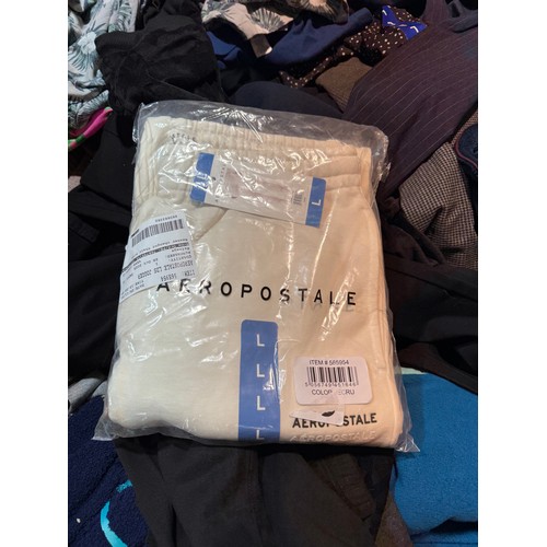 6083 - A pallet of mixed clothing to include trousers, shirts, jeans, hoodies, etc. Various brand styles an... 