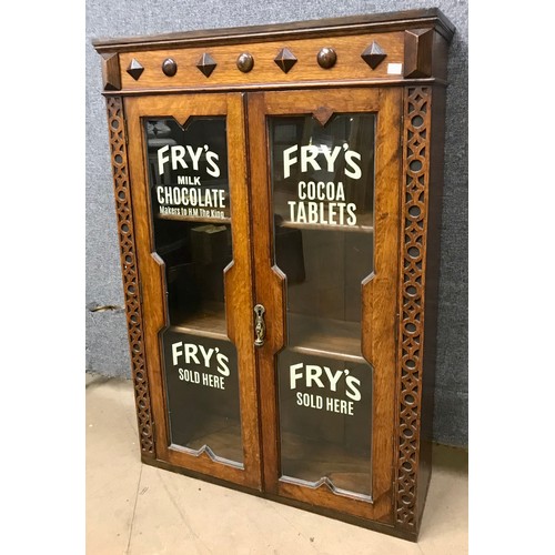 262 - A large carved oak shop display cabinet bearing Fry's Chocolate inscription