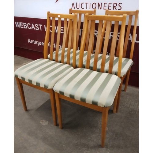 61B - A set of four beech dining chairs
