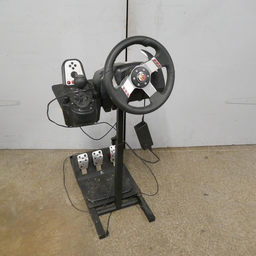 A Logitech racing simulation set up with steering wheel, pedals and ...