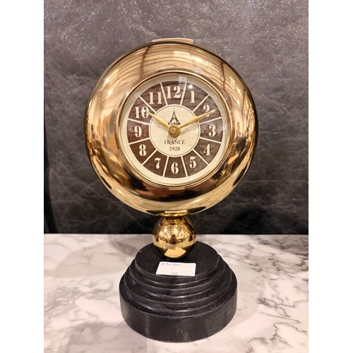 3008 - A Minster gold effect mantle clock on a circular black marble base