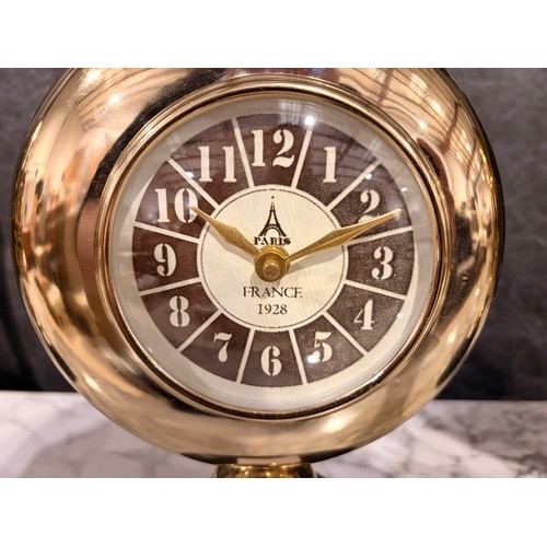 3008 - A Minster gold effect mantle clock on a circular black marble base