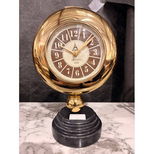 3017 - A Minster gold effect mantle clock on a circular black marble base