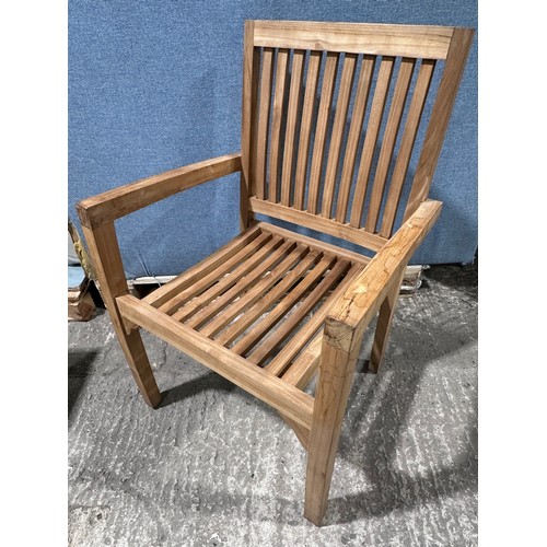 3040 - A teak circular folding garden table and a pair of teak carver chairs