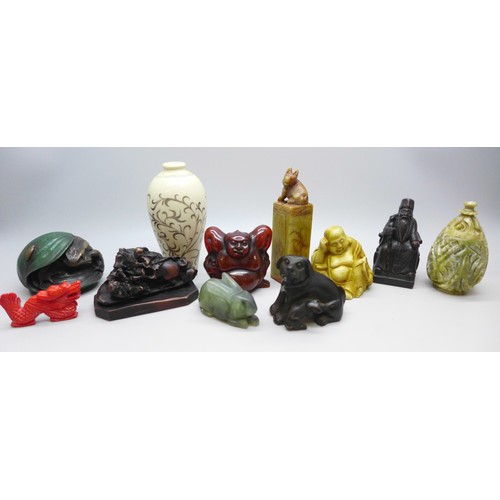 2192 - A collection of oriental items to include carved hardstone seal, carved Japanese amber netsuke of a ... 
