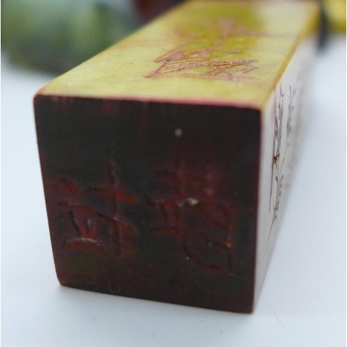2192 - A collection of oriental items to include carved hardstone seal, carved Japanese amber netsuke of a ... 