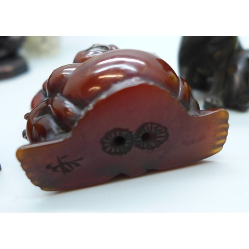 2192 - A collection of oriental items to include carved hardstone seal, carved Japanese amber netsuke of a ... 
