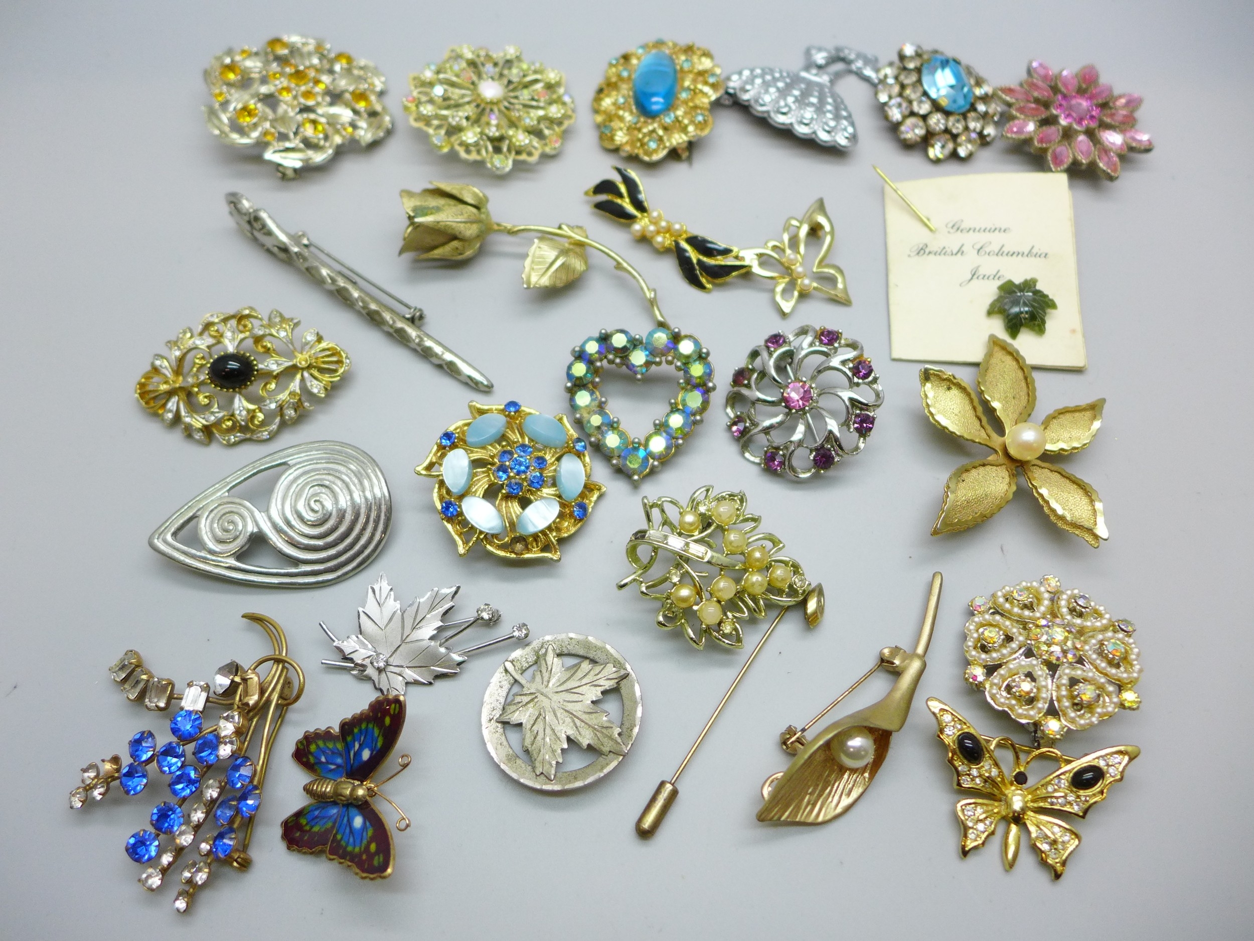A collection of costume brooches including two silver examples