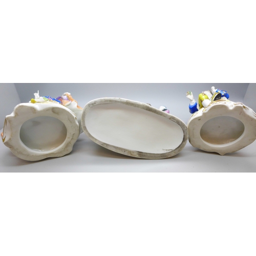 2022 - A pair of figures, seated lady and gentleman with gold anchor marks and one other continental figure... 