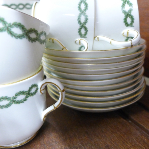2055 - A George Jones and Sons 'Crescent' tea service with green ivy banded decoration, 10x tea cups, 12x s... 