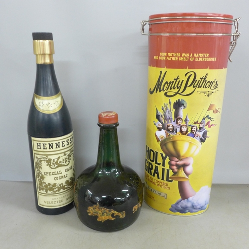 2141 - A Thorens musical glass bottle, together with a Hennessy Pull Up cigarette holder in the shape of a ... 