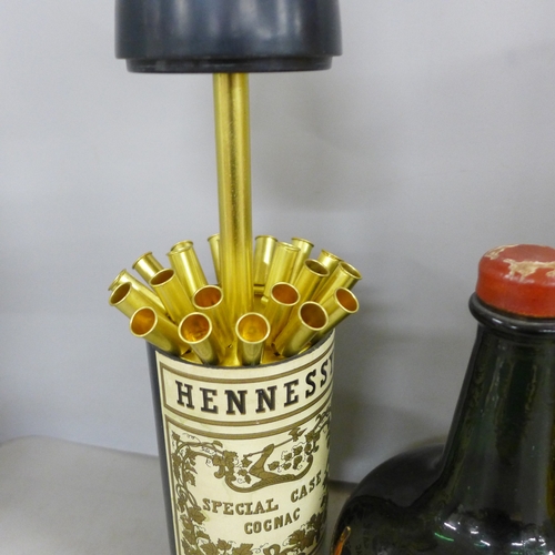 2141 - A Thorens musical glass bottle, together with a Hennessy Pull Up cigarette holder in the shape of a ... 