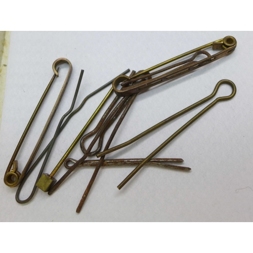 2170 - A collection of military cap badges, and a button polishing guard