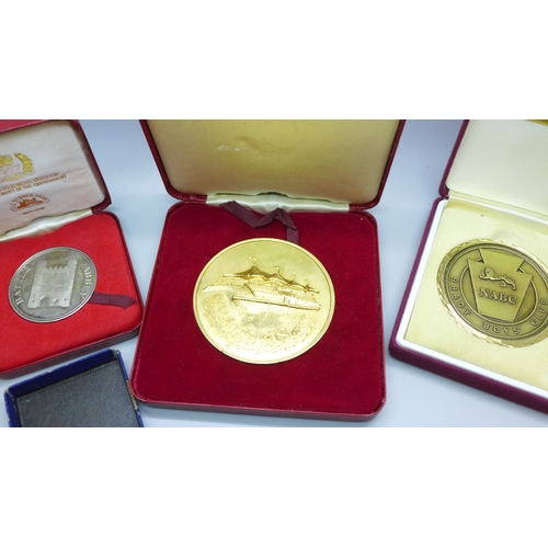2180 - A 1953 Coronation medallion, a camel racing medallion, two other medallions and a replica medal, all... 