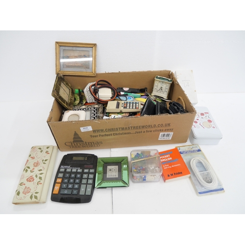2219 - A box of miscellaneous items to include calculators, travel clocks, picture frames, etc.