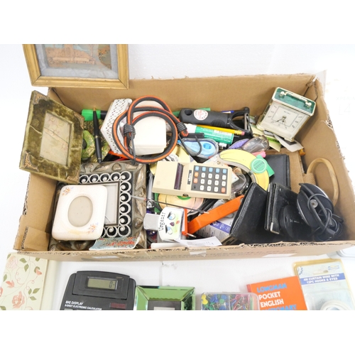 2219 - A box of miscellaneous items to include calculators, travel clocks, picture frames, etc.