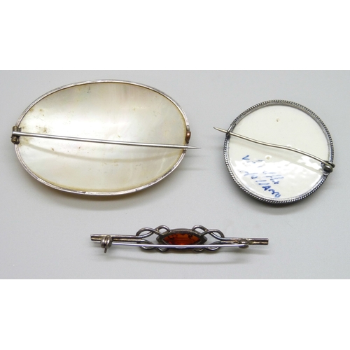 7067 - A large early 20th Century white metal and mother of pearl brooch, a white metal framed Dutch delft ... 