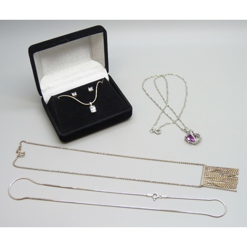 7111 - Two silver chains, a plated heart pendant on a plated chain, and a pair of silver earrings and a sil... 