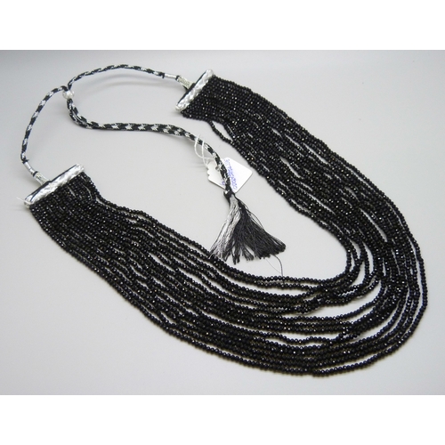 7128 - A fifteen strand black glass bead necklace, 110g