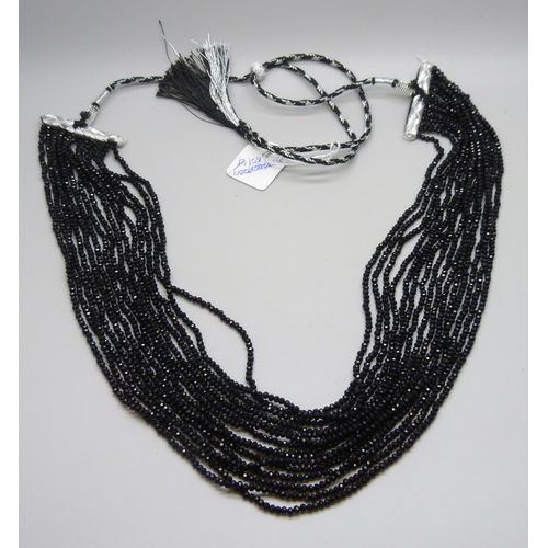 7128 - A fifteen strand black glass bead necklace, 110g