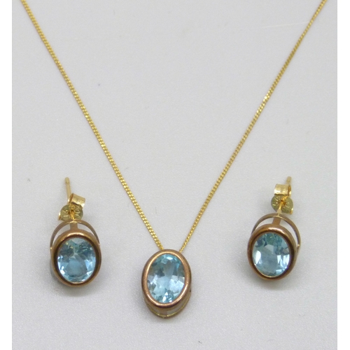 7133 - A yellow metal and topaz jewellery set - a pendant on a 9ct gold chain, and a pair of earrings, 2.2g... 