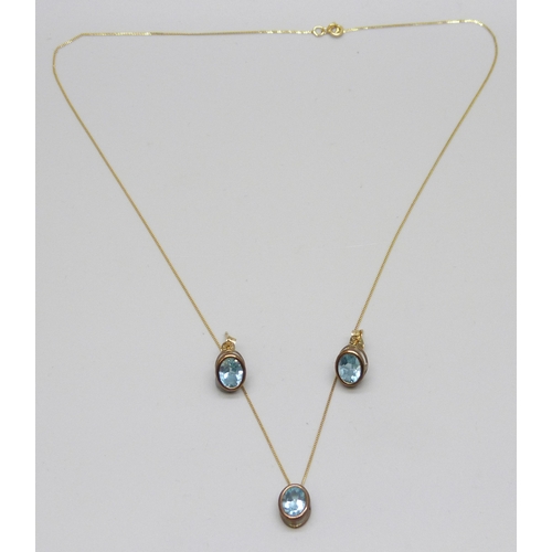 7133 - A yellow metal and topaz jewellery set - a pendant on a 9ct gold chain, and a pair of earrings, 2.2g... 
