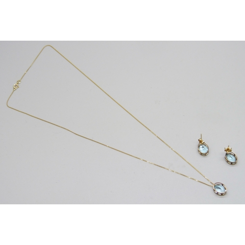7133 - A yellow metal and topaz jewellery set - a pendant on a 9ct gold chain, and a pair of earrings, 2.2g... 