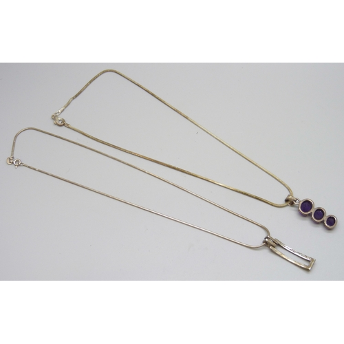 7136 - A silver and amethyst pendant on a plated chain, and a silver pendant on a silver chain