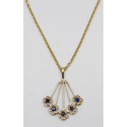 7137 - A 9ct gold and sapphire floral fan design pendant, 2.8cm including bail, on a yellow metal chain, 5.... 