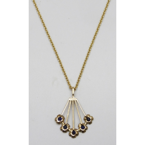 7137 - A 9ct gold and sapphire floral fan design pendant, 2.8cm including bail, on a yellow metal chain, 5.... 
