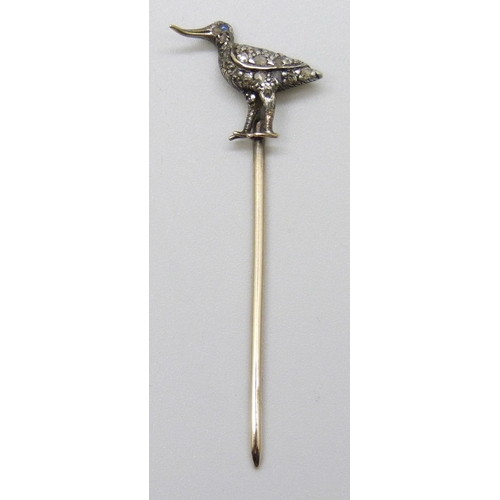 7145 - A yellow metal diamond set stick pin in the form of a bird set with a sapphire eye, length altered, ... 