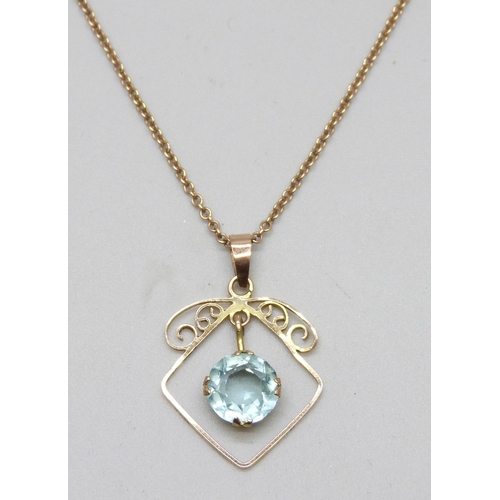 7150 - An early 20th Century yellow metal blue paste stone set pendant, 2.4cm, on a 9ct gold chain, 2.5g to... 