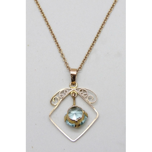 7150 - An early 20th Century yellow metal blue paste stone set pendant, 2.4cm, on a 9ct gold chain, 2.5g to... 
