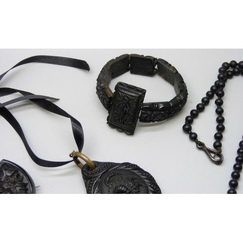 7160 - A collection of Whitby Jet and bog oak including a chain, and a pair of French jet buckles