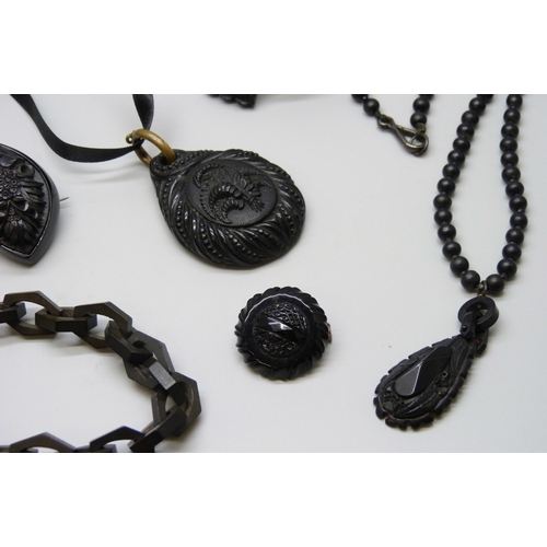 7160 - A collection of Whitby Jet and bog oak including a chain, and a pair of French jet buckles