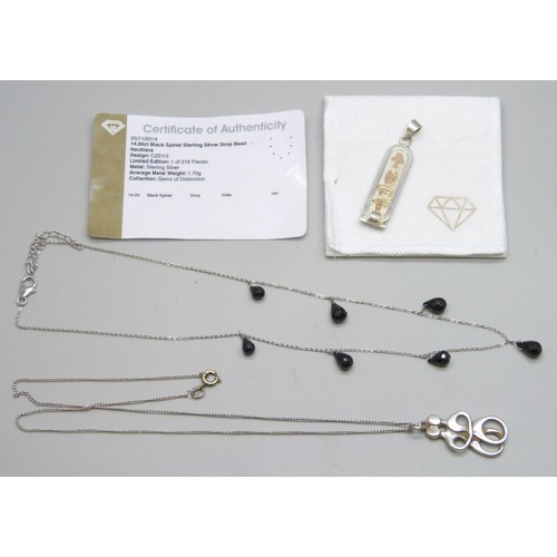 7100 - A silver mounted black spinel necklace, an Egyptian silver pendant with yellow metal overlay, and a ... 