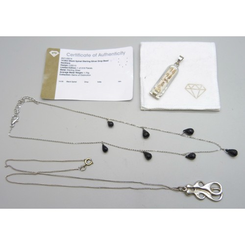 7100 - A silver mounted black spinel necklace, an Egyptian silver pendant with yellow metal overlay, and a ... 