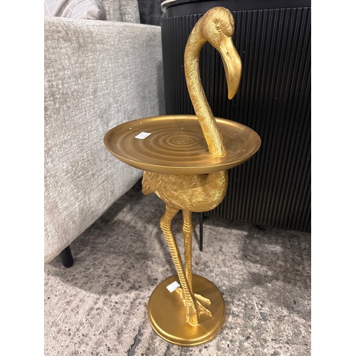 A gold effect flamingo side table