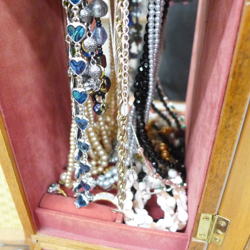 2062 - A jewellery box with rings, bracelets, etc., and a box of clip-on earrings