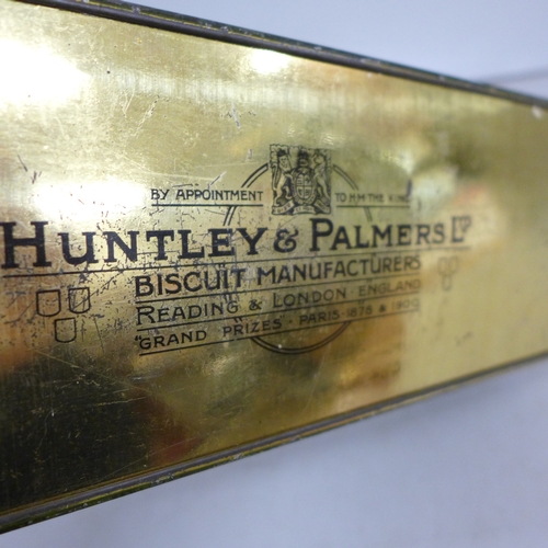 2080 - A Huntley and Palmer biscuit tin, a white metal spoon and ice nips, and some plated flatware