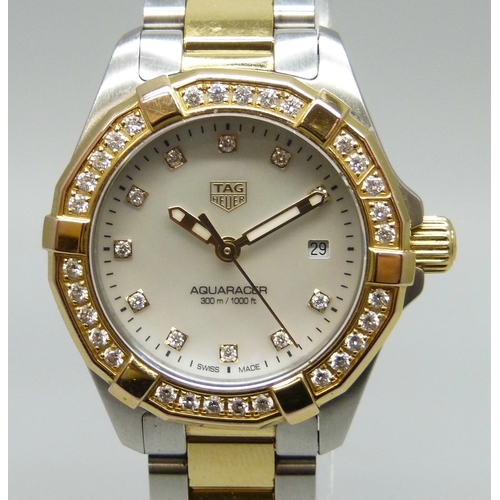 7361 - Tag Heuer - a lady's Aquaracer wristwatch with a diamond set rotating bezel, stainless steel case, m...