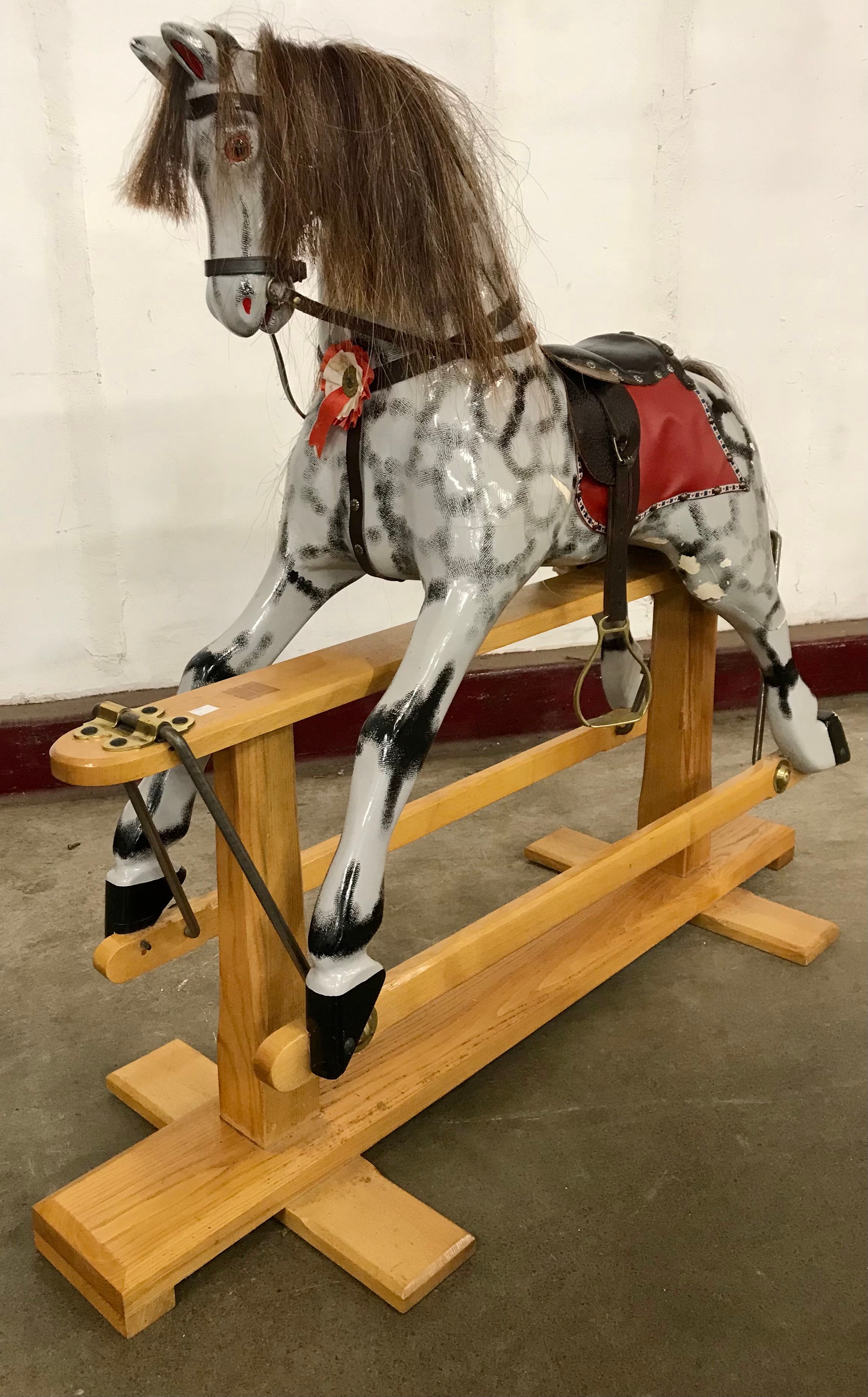 A Victorian painted dapple grey rocking horse, on beech trestle stand