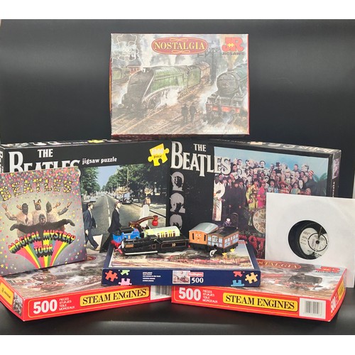 2126 - Two The Beatles jigsaw puzzles, a Magical Mystery Tour record, other jigsaws and some toy vehicles